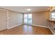 Bright dining room with wood-look flooring, neutral walls, and a window providing natural light at 1665 South Dr, Columbus, IN 47203