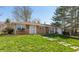 Charming brick ranch-style home with a well-manicured lawn and walkway leading to the front door at 1665 South Dr, Columbus, IN 47203
