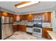 A well-equipped kitchen showcasing stainless steel appliances and ample wooden cabinetry at 1665 South Dr, Columbus, IN 47203