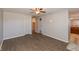 Open living room with wood-look floors, two closets, and an entryway leading to the kitchen at 1665 South Dr, Columbus, IN 47203