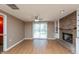 Spacious living room with a brick fireplace, built-in shelving, and sliding glass doors leading to the backyard at 1665 South Dr, Columbus, IN 47203