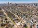 An aerial view showcases modern townhomes nestled in a vibrant neighborhood with the city skyline in the distance at 1811 Livery Way, Indianapolis, IN 46202
