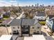 Aerial view of suburban neighborhood with modern townhomes and cityscape in the distance at 1811 Livery Way, Indianapolis, IN 46202