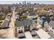 An aerial view showcasing modern townhomes nestled in a vibrant neighborhood with the city skyline in the distance at 1811 Livery Way, Indianapolis, IN 46202