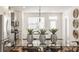 Dining area with glass table, kitchen view, and stylish decorations at 1811 Livery Way, Indianapolis, IN 46202