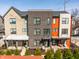 Modern townhomes with brick and siding exteriors, black trim, and a landscaped front yard at 1811 Livery Way, Indianapolis, IN 46202