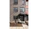 Modern brick condo with front door entry featuring dark trim and landscaping at 1811 Livery Way, Indianapolis, IN 46202