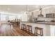 Open kitchen with stainless steel appliances and modern island with seating at 1811 Livery Way, Indianapolis, IN 46202