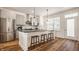 Modern kitchen featuring stainless appliances, kitchen island, and tile backsplash at 1811 Livery Way, Indianapolis, IN 46202