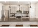 Kitchen with modern stainless appliances and island featuring barstool seating at 1811 Livery Way, Indianapolis, IN 46202