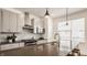 Modern kitchen features stainless steel appliances, gray cabinets, and stylish pendant lighting at 1811 Livery Way, Indianapolis, IN 46202