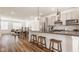 Spacious kitchen with bar seating overlooking a dining area and living room at 1811 Livery Way, Indianapolis, IN 46202