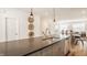 Kitchen island with stainless steel sink, dishwasher, and bar seating open to the living room at 1811 Livery Way, Indianapolis, IN 46202
