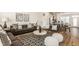 Open-concept living area featuring modern decor, stylish furnishings, and a seamless flow to the dining and kitchen at 1811 Livery Way, Indianapolis, IN 46202