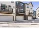 A row of townhomes and attached garages on a sunny day at 1811 Livery Way, Indianapolis, IN 46202