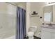 This bathroom includes a shower with curtain, toilet, and vanity with sink at 1896 Woodland Parks Dr, Columbus, IN 47201