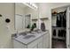 This bathroom boasts a double sink vanity, large mirror, and closet at 1896 Woodland Parks Dr, Columbus, IN 47201