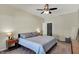 This bedroom features neutral walls, ceiling fan, and bedside table with lamp at 1896 Woodland Parks Dr, Columbus, IN 47201