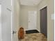 This entryway has a door, mat, and wall mounted light switch at 1896 Woodland Parks Dr, Columbus, IN 47201