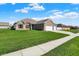 Traditional brick home with a three-car garage and manicured front lawn at 1896 Woodland Parks Dr, Columbus, IN 47201