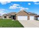 Charming single-story brick home with a manicured lawn and a three car attached garage at 1896 Woodland Parks Dr, Columbus, IN 47201