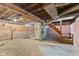 Unfinished basement with exposed brick and beams, offering potential for customization and additional living space at 2501 Reformers Ave, Indianapolis, IN 46203