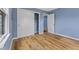 Spacious bedroom with light wood flooring, blue walls, and a closet at 2501 Reformers Ave, Indianapolis, IN 46203