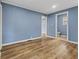 This room has light wood flooring, blue painted walls, and two doorways at 2501 Reformers Ave, Indianapolis, IN 46203