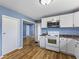 The kitchen is modernized with white cabinets and features stainless steel appliances at 2501 Reformers Ave, Indianapolis, IN 46203