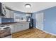 The kitchen features bright white cabinets, stainless appliances, and new flooring at 2501 Reformers Ave, Indianapolis, IN 46203