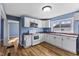 This kitchen is modernized with white cabinets and features stainless steel appliances at 2501 Reformers Ave, Indianapolis, IN 46203