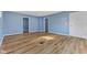 Room with light wood flooring, blue painted walls, and several doorways at 2501 Reformers Ave, Indianapolis, IN 46203