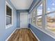 This bright and airy sunroom features new replacement windows and vinyl floors at 2501 Reformers Ave, Indianapolis, IN 46203