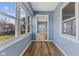 This sunroom is bright and airy with replacement windows and new vinyl floors at 2501 Reformers Ave, Indianapolis, IN 46203