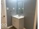 This bathroom features a vanity with white cabinets, a mirror, and light gray walls at 3014 Arbor Ave, Indianapolis, IN 46217