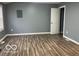Bedroom with wood flooring, gray walls, and natural light at 3014 Arbor Ave, Indianapolis, IN 46217
