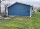 View of the side of the home displaying the blue siding and the surrounding yard at 3014 Arbor Ave, Indianapolis, IN 46217