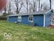 The exterior side showcases the blue siding, white trim and a well-maintained lawn at 3014 Arbor Ave, Indianapolis, IN 46217