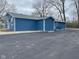 Side view of the home with blue siding and a paved driveway area at 3014 Arbor Ave, Indianapolis, IN 46217