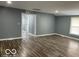 Spacious living room featuring wood flooring and natural light from a large window at 3014 Arbor Ave, Indianapolis, IN 46217
