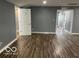 Open-concept living room featuring a doorway and wood flooring at 3014 Arbor Ave, Indianapolis, IN 46217