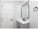 This bathroom features a gray vanity with a white countertop, black faucet, and modern lighting fixtures at 3153 Stillmeadow Dr, Indianapolis, IN 46214