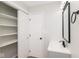 Bathroom featuring a white vanity and a mirrored medicine cabinet, along with a large storage closet at 3153 Stillmeadow Dr, Indianapolis, IN 46214