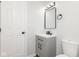 Updated bathroom featuring a grey vanity, black hardware and a mirrored medicine cabinet at 3153 Stillmeadow Dr, Indianapolis, IN 46214