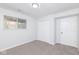 This bedroom features neutral carpeting, white walls, a closet and a window at 3153 Stillmeadow Dr, Indianapolis, IN 46214