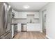 Modern kitchen with stainless steel appliances, white cabinetry, and sleek countertops at 3153 Stillmeadow Dr, Indianapolis, IN 46214