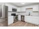 Bright kitchen with stainless steel appliances, white cabinets, and modern countertops at 3153 Stillmeadow Dr, Indianapolis, IN 46214