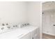Modern laundry room with a new washer and dryer and access to a beautifully remodeled standing shower at 3153 Stillmeadow Dr, Indianapolis, IN 46214