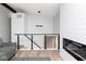 Light-filled living area with modern fireplace, LVP flooring, stylish railing, and comfortable seating at 3153 Stillmeadow Dr, Indianapolis, IN 46214