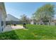 This backyard features a well-maintained lawn, patio, grill, storage shed, and a full perimeter fence at 329 Dogwood Dr, Pendleton, IN 46064